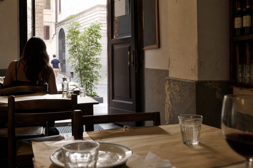 A traditional Florentine trattoria interior with paper tablecloths and chalkboard menu, no text, no logos, no people