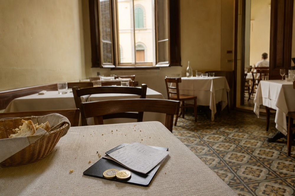 A handwritten restaurant bill in Florence showing a coperto line, no text, no logos, no people
