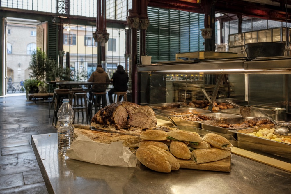 A market food stall in Florence with sandwiches and trays of prepared dishes, no text, no logos, no people