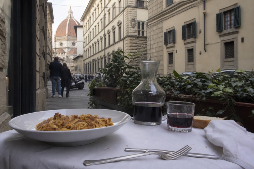 A bowl of fresh pasta with sauce on a trattoria table in Florence, no text, no logos, no people