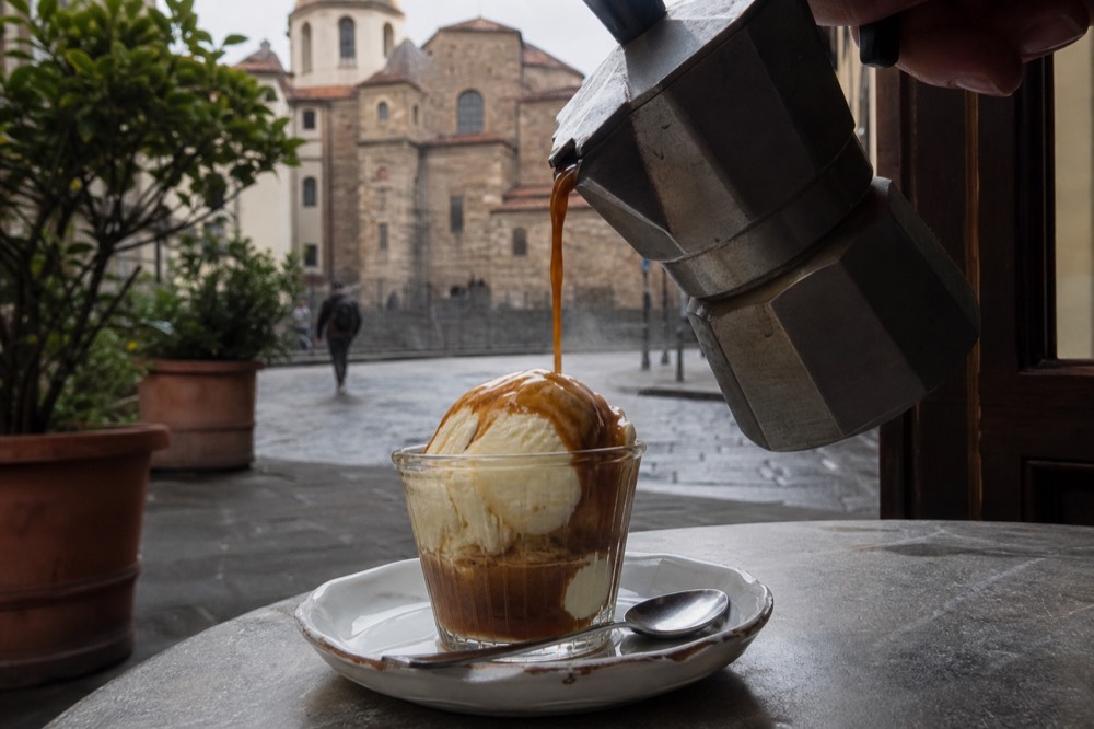 Espresso being poured over gelato for an affogato, no text, no logos, no people