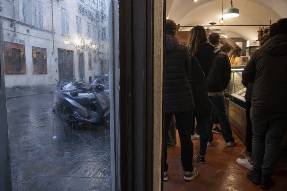 A gelateria interior with a small service counter and customers waiting, no text, no logos, no people