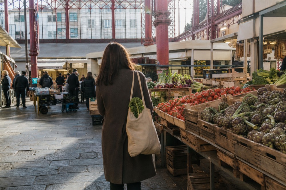 A historic Florence food market hall with produce stalls under iron and glass, no text, no logos, no people
