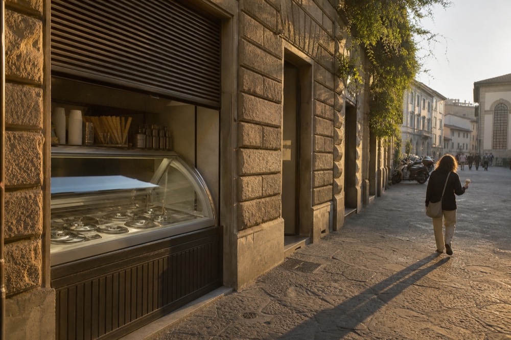 Gelateria storefront in Florence with covered metal tubs visible, no text, no logos, no people