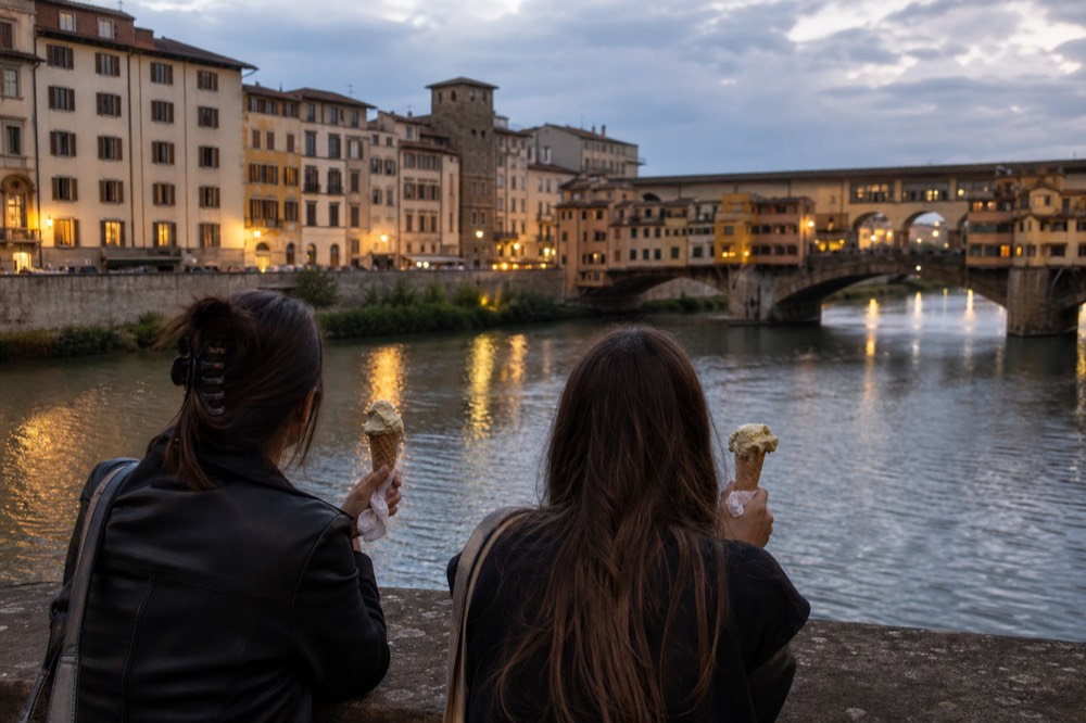People enjoying gelato by the Arno River, no text, no logos, no people