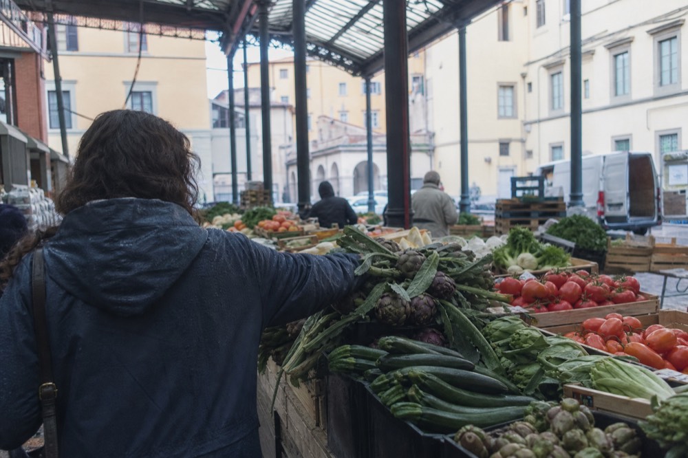 A Florence market stall with fresh vegetables and produce laid out in crates, no text, no logos, no people