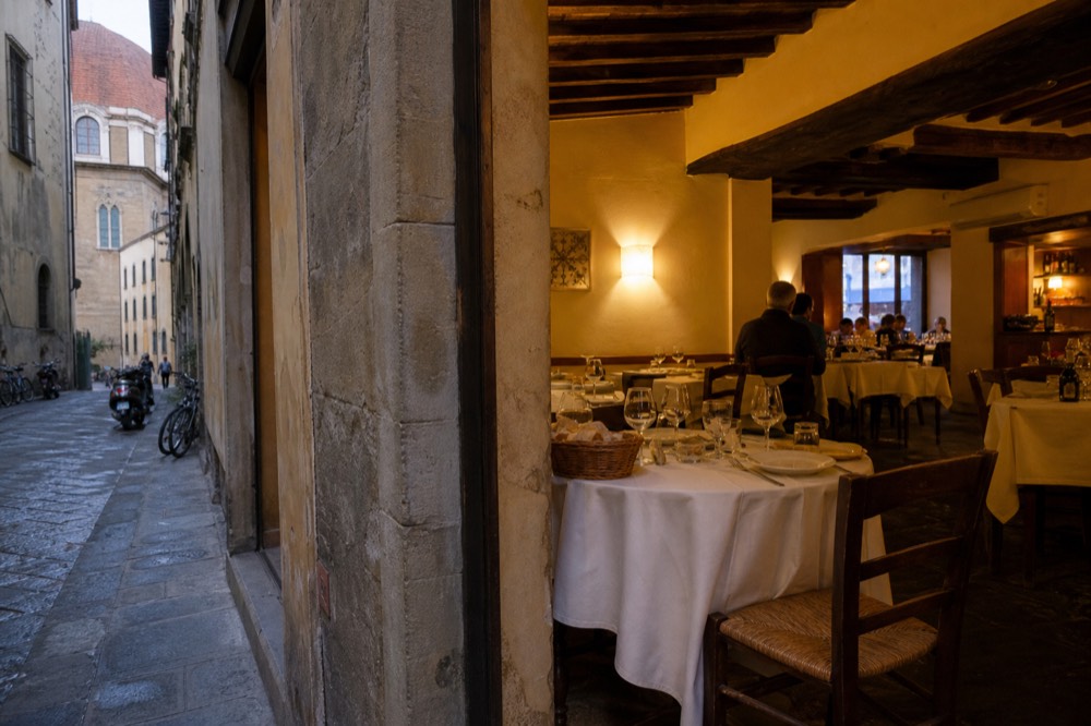 A small traditional Florentine dining room set for dinner, no text, no logos, no people