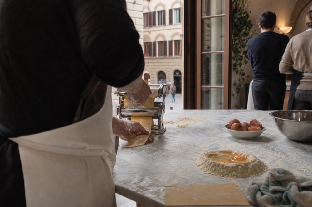 Fresh pasta being prepared by hand in a Florence cooking class, no text, no logos, no people