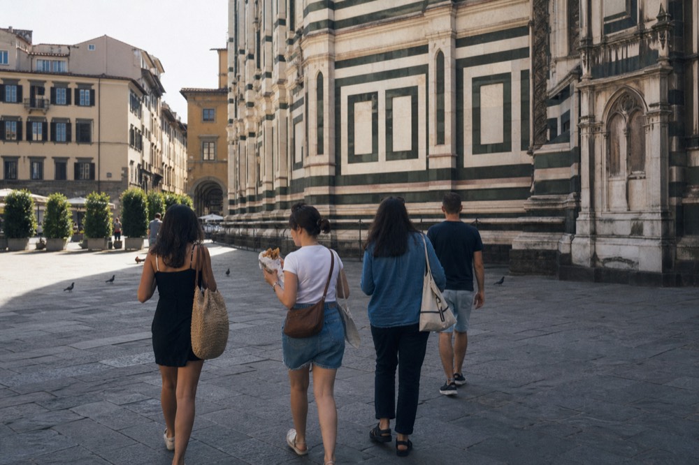 A guided walking group on a Florence street near the Duomo, no text, no logos, no people