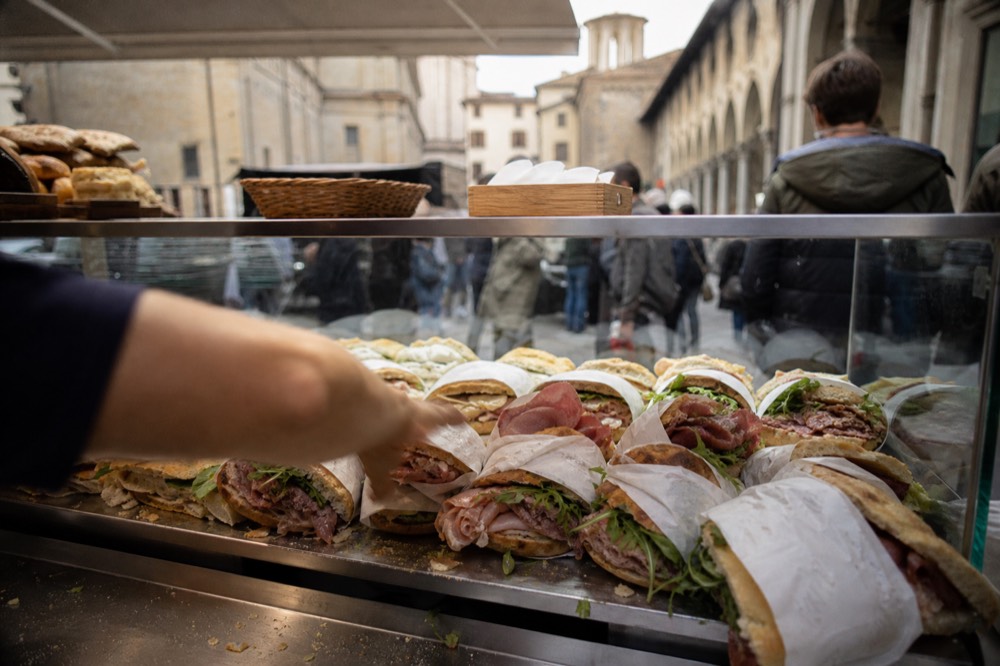 A sandwich counter with flatbread and filled rolls on display, no text, no logos, no people