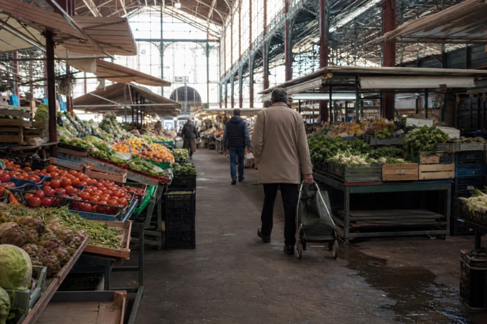 A covered market hall with produce stalls and counters, no text, no logos, no people