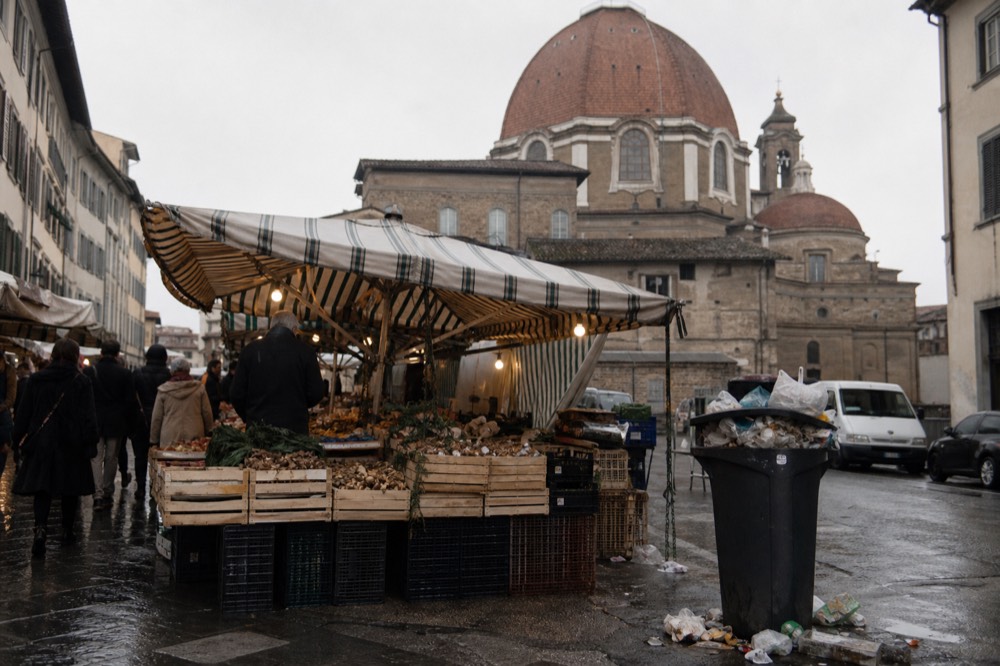 Wide shot of Mercato Centrale exterior with San Lorenzo market stalls in foreground, no text, no logos, no people