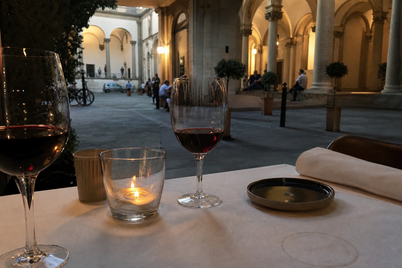 Elegant fine dining table with white linen and wine glasses in a Florence restaurant, no text, no logos, no people