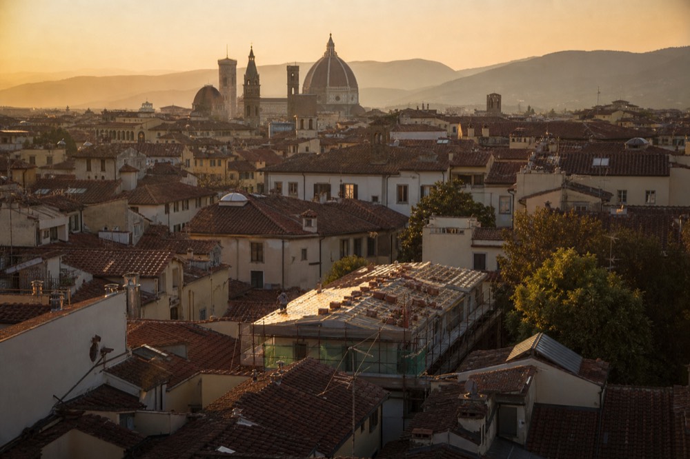Evening light over Florence rooftops with the cathedral dome, no text, no logos, no people
