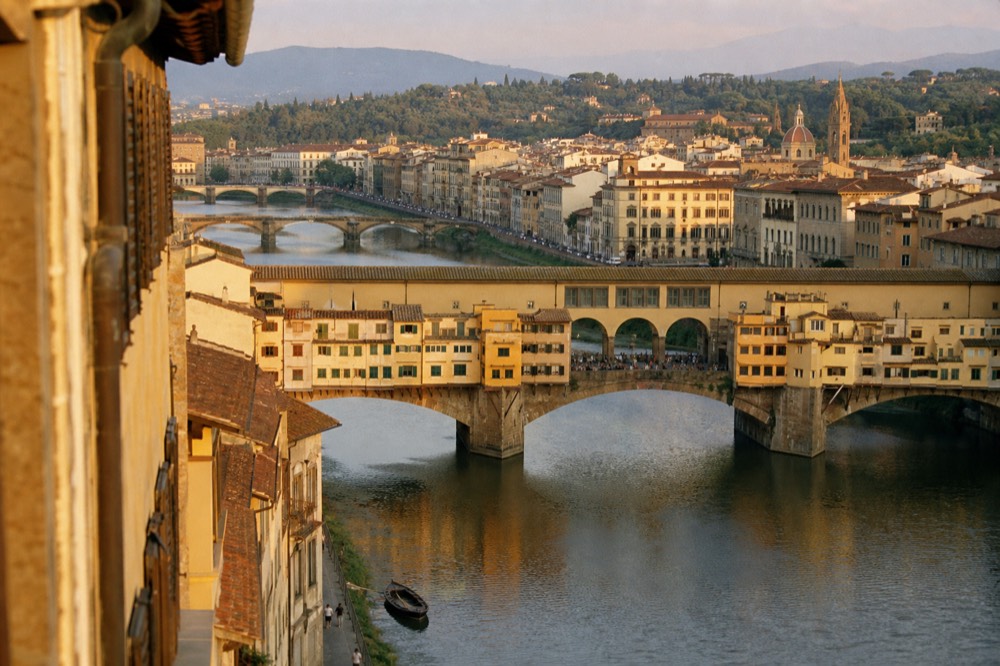 Ponte Vecchio and the Arno at golden hour from above, no text, no logos, no people