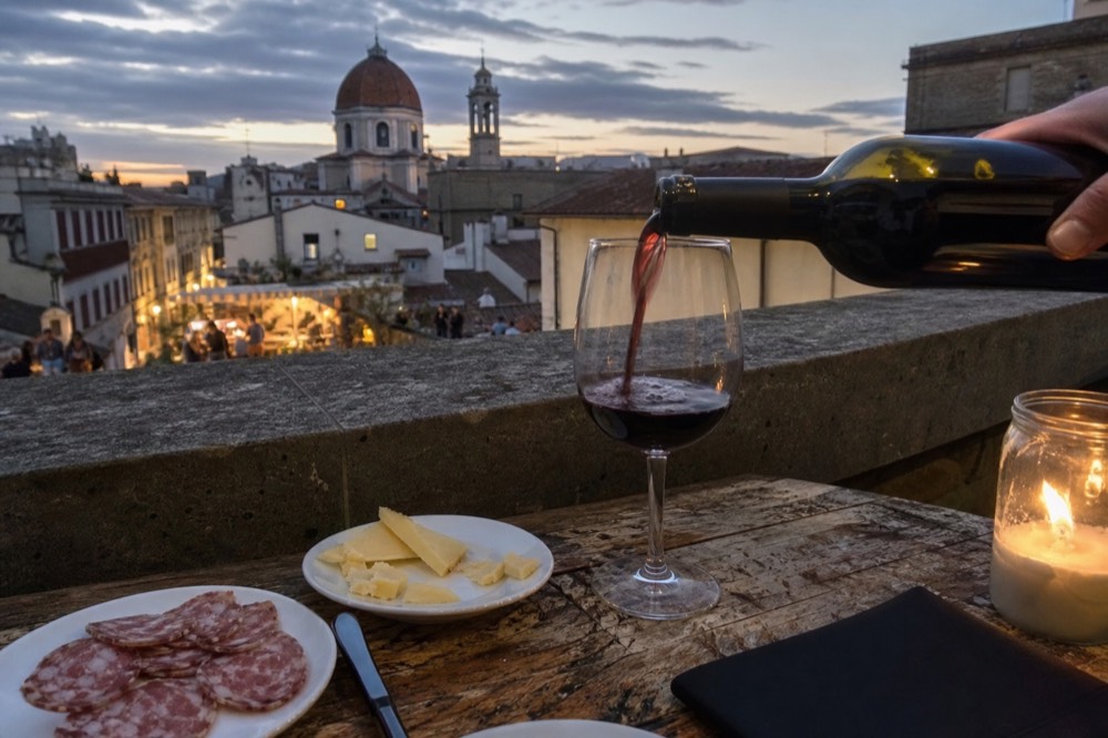 Wine and food served at a Florence tasting table, no text, no logos, no people