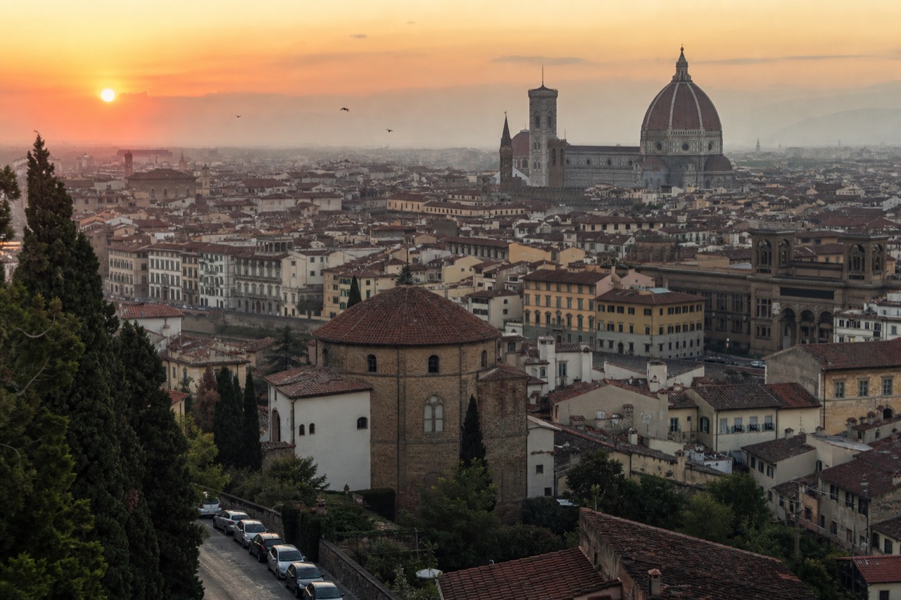 Florence rooftops and the Duomo seen from above at sunset, no text, no logos, no people
